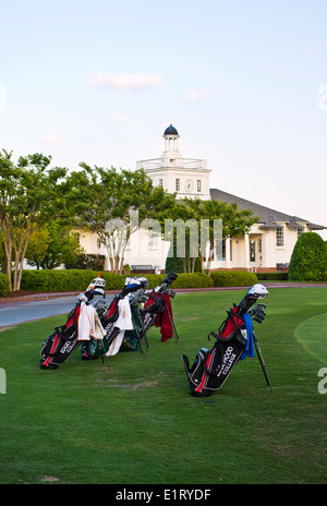 Golf Club Bags at the edge of the putting practice area at the clubhouse at Pinehurst Golf Resort & Country Club in Pinehurst NC Stock Photo