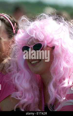 Race for Life, Cancer Research UK charity event, woman wearing pink wig and sunglasses. Stock Photo