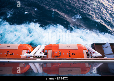 View down onto lifeboats of MV Arcadia in the early evening light whilst she sails in the North Sea Stock Photo