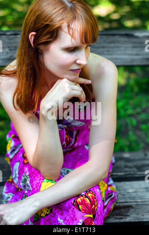 Pretty girl sitting on the bench Stock Photo