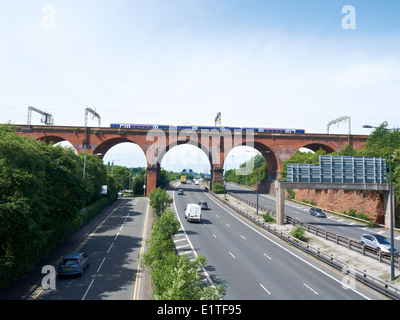 Stockport viaduct over the M60 Motorway with passing train in Stockport Cheshire UK Stock Photo