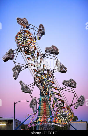 Amusement Park Ride (The Zipper) at dusk, Morden Corn and Apple Festival, Morden, Manitoba, Canada Stock Photo