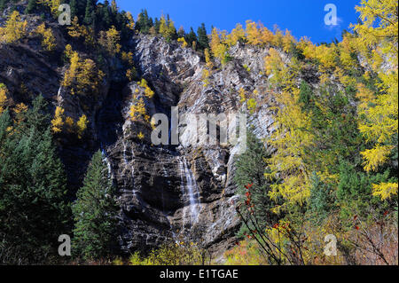 View of a waterfall from a walking path in autumn in JiuZhaiGou National Park in Sichuan Province, P.R. China. Stock Photo