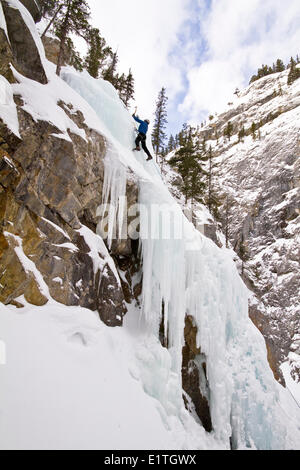 Young man ice-climbing in Banff National Park near Banff, Alberta, Canada. Stock Photo
