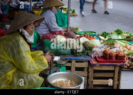 Hoi An’s central market food hall provides delicious Vietnamese food. It is surrounded by a busy, colourful food market. Stock Photo