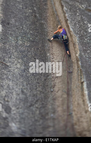 A strong female climber climbs a corner crack, Caboose 10b, Squamish, BC Stock Photo