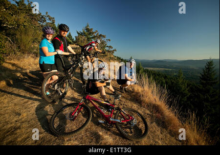 A group of friends stop for a rest on Mt. Tzoulalem, Duncan, Central Vancouver Island, British Columbia, Canada Stock Photo