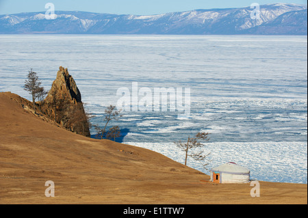 Russia, Siberia, Irkutsk oblast, Baikal lake, Maloe More (little sea), frozen lake during winter, Olkhon island, Shaman rock Stock Photo