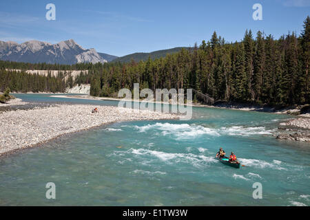 Two men paddle canoe on Kootenay River, Kootenay National Park, BC, Canada. Stock Photo
