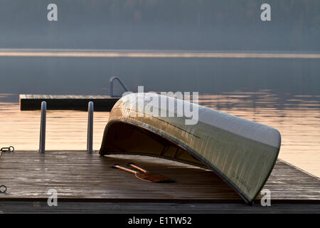 Canoe on dock in early morning, Source Lake, Algonquin Park, Ontario, Canada. Stock Photo