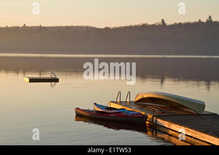 Canoe and kayaks on dock, Source Lake, Algonquin Park, Ontario, Canada. Stock Photo