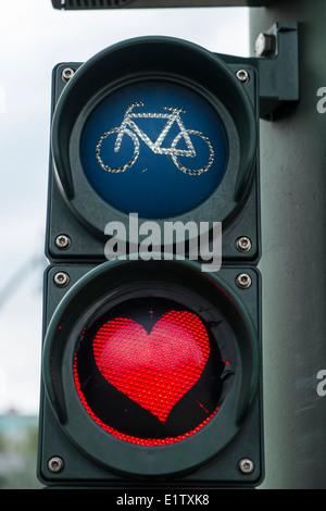 Red heart painted on stop light for bicycles in Berlin Germany Stock Photo