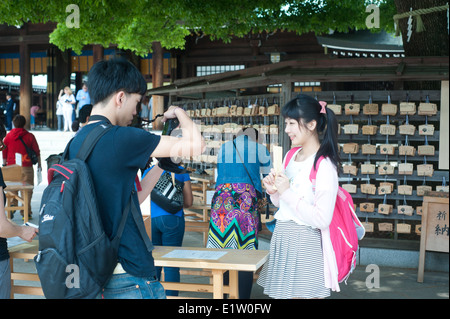 Tokyo Japan 2104 - Writing prayers and wishes on a wooden ema prayer tablet. Stock Photo