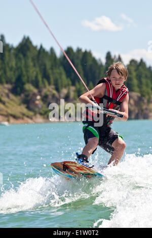 Young boy wakeboarding on Lake Koocanusa, East Kootenays, BC, Canada Stock Photo