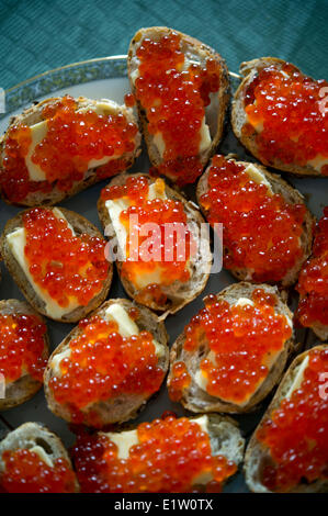 Red caviar sandwiches placed in a plate on a table Stock Photo