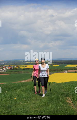 women nordic walking through rural landscape Stock Photo