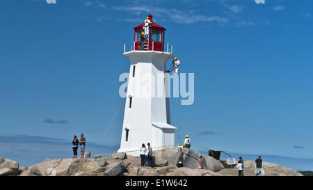 Maintenance group works on Peggy's Point Lighthouse, Peggy's Cove, Nova Scotia, Canada Stock Photo