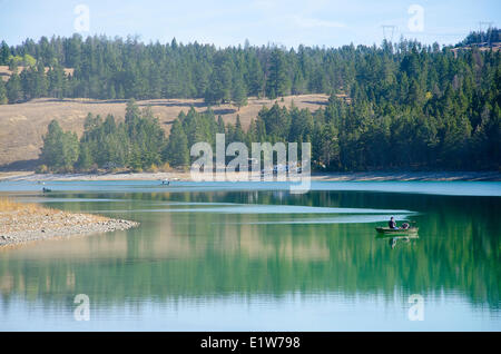 Fisherman enjoys a day on Lundbom Lake near Merritt in the Nicola Valley of British Columbia, Canada Stock Photo