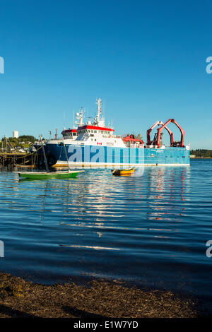 Small wooden boats and fishing boat, Lunenburg waterfront, Nova Scotia, Canada Stock Photo