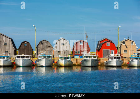 Fishing boats tied up at Malpeque Harbour wharf, Prince Edward Island, Canada Stock Photo