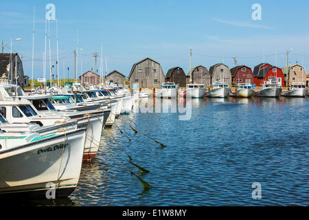 Fishing boats tied up at Malpeque Harbour wharf, Prince Edward Island, Canada Stock Photo