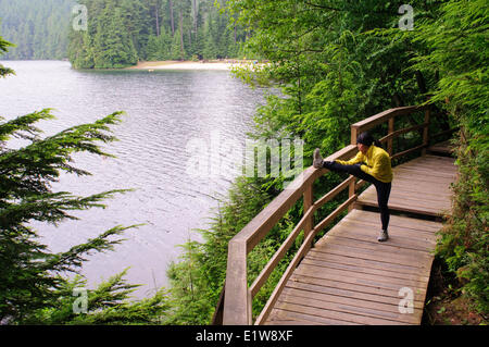 Running and hiking on the trail around Sasamat Lake, Belcarra Regional Park, Port Moody, British Columbia, Canada Stock Photo