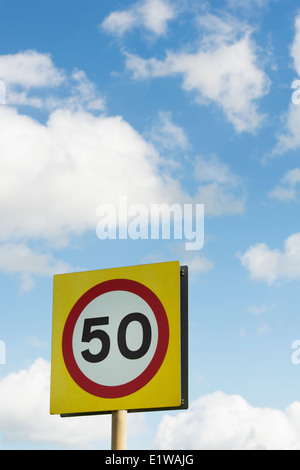 50 MPH Speed limit road sign against blue cloudy sky. England Stock Photo