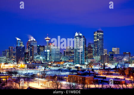 Calgary skyline at night in winter showing office towers including Bow Tower, Calgary, Alberta, Canada. Stock Photo