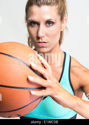 Muscular toned athletic woman - basketball player Stock Photo