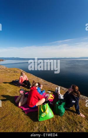 A family outing turns to laughter while having lunch along the cliffs Helliwell on Hornby Island.  Hornby Island Northern Gulf Stock Photo