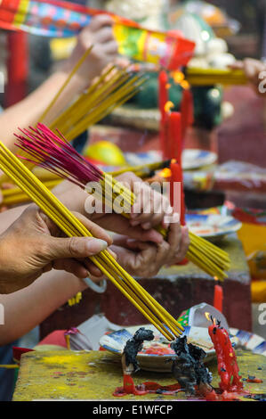 Worshipers burn incense candles at a Chinese temple in Ho Chi Minh City, Socialist Republic of Vietnam. Stock Photo