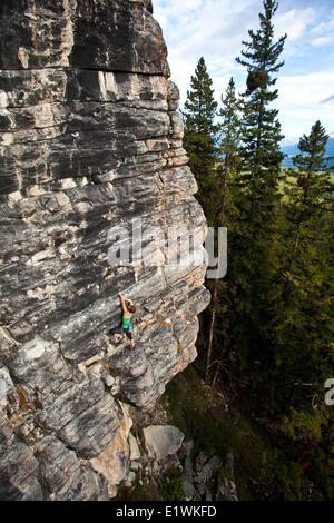 A strong female climber works on Supernatural zombie suspense thriller 11d, Silver City, Castle Mtn, Banff, AB Stock Photo