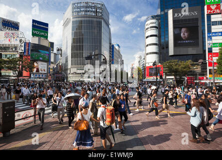 Famous Shibuya Crossing in Tokyo, Japan. Located next to the Shibuya train station, traffic lights stop vehicles coming from all Stock Photo