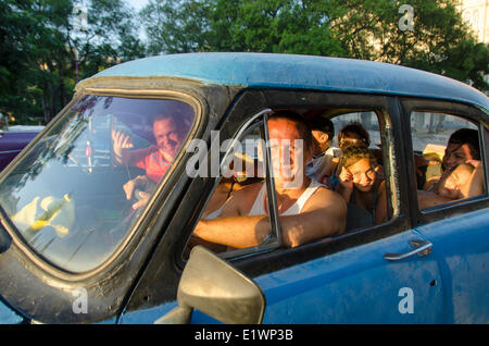 Cuban people in old car, Havana, Cuba Stock Photo