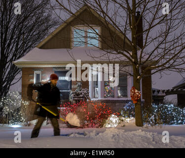 Man shovling snow after a snow fall on chrismas Stock Photo