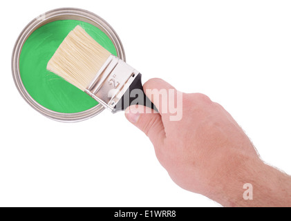 hand about to dip brush into a pot of paint isolated on a white background Stock Photo