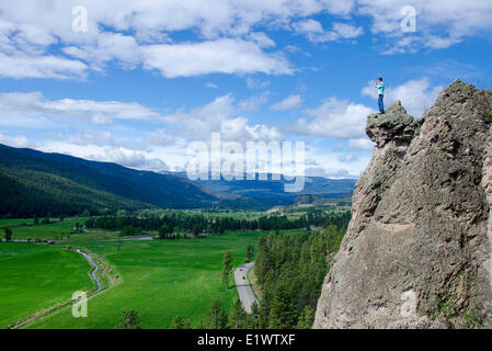 Hiker photographs from top of hoodoos, near Merritt, British Columbia, Canada. MR 007. Stock Photo