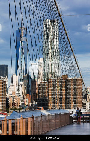 Lower Manhattan as seen through the cables that support the Brooklyn Bridge. The tallest buildings in the photograph are the New Stock Photo