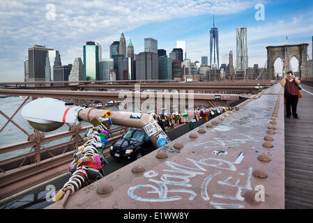 Love padlocks affixed to the bracing of a street lamp on the Brooklyn Bridge. Such locks often carry the names of the lovers who Stock Photo