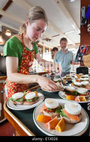 Salmon benedict being prepared aboard Columbia III for waiting guests. Broughton Archipelago Central British Columbia Coast Stock Photo
