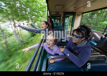 A mother children enjoy the open air passenger cars on the Alberni Pacific Steam Train enroute Port Alberni to the McLean Mill Stock Photo