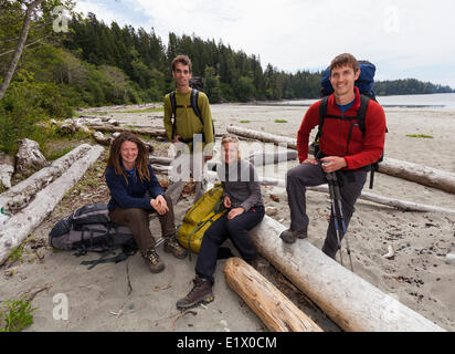 Four friends pose for a photo before embarking on their West Coast Trail adventure.  Bamfield Vancouver Island British Columbia Stock Photo