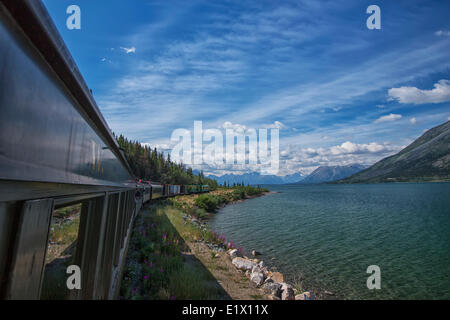 Riding the White Pass and Yukon Route train along the shores of Bennett Lake, Yukon. Stock Photo