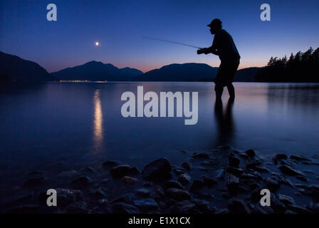 Man Fly fishing, sunset, Greenpoint, Harrison Lake near Harrison Hot Springs, British Columbia, Canada Stock Photo