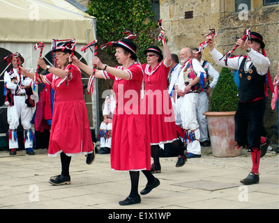 Dancers of the morris dancing group 'Ragged and Old Morris' dancing at a venue near Winchcombe, Gloucestershire. Stock Photo