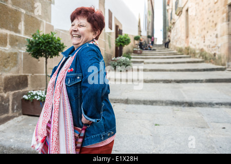 Senior Woman dancing on the streets of an old town. Stock Photo