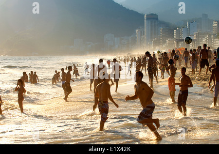 RIO DE JANEIRO, BRAZIL - JANUARY 20, 2014: Young Brazilians splashing on Ipanema Beach playing beach football altinho. Stock Photo