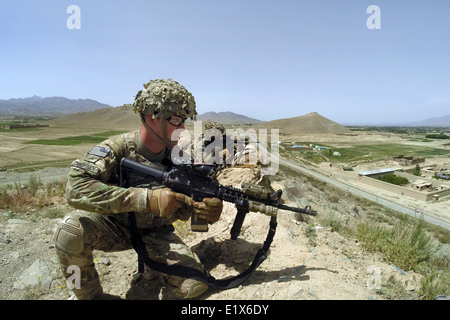 US Army soldiers with the 10th Mountain Division watch a road during a patrol May 29, 2014 in Paktia Province, Afghanistan. Stock Photo