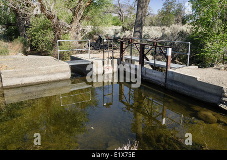 water diversion structures to control the flow of water from an irrigation canal in the Owens Valley Stock Photo