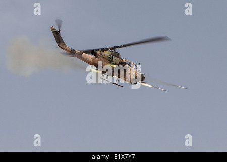 A Jordanian Armed Forces AH-1F Cobra attack helicopter fires rockets during live-fire exercise as part of Eager Lion June 23, 2014 in Jebel Petra, Jordan. Stock Photo